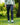 Model wearing the Ace Pants outside with greenery in the background