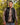 Model wearing the Onyx Crosscut Vest outside with greenery in the background