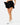 Model showing the Flair of the skort in front of a light gray background