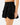 Side profile of the Flairway Skort featuring the Waggle "W" Logo. Skort is on a Model in front of a light gray background