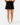 Back of the Onyx Pacesetter Skort on a model in front of a light gray background.
