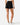 Back of the Onyx Momentum Shorts on a model in front of a light gray background.