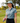Female model wearing the Pine High Polo on the golf course with greenery in the background