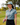Female model wearing the Pine High Polo on the golf course with greenery in the background