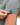 Waggle W logo on the left sleeve of the Pine High Polo on a model in front of a white background