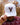 Model wearing the Rack Star Hat outside doing a hat tilt with trees in the background.