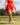 Model wearing the Flairway skort on the golf course with greenery in the background