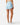 Back of the Sky Blue Momentum Shorts on a model in front of a light gray background.