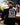 Male model wearing the Slice of Death Long Sleeve T-Shirt at a Brewery with greenery and people in the background