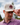 A male model wearing the Smoaked It Hat with greenery & blue sky in the background