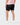 Back of the Speckled Onyx Momentum Shorts on a model in front of a light gray background.