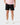 Front of the Speckled Onyx Momentum Shorts on a model in front of a light gray background.