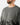 Close up on the Collar on the Squatch Wildknit Sweater on a Male Model in front of a light gray background.