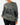 Front of the Squatch Wildknit Sweater on a Female Model in front of a light gray background.