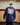 Male model wearing the Sticks in the Middle Long Sleeve T-Shirt walking out of a hockey locker room