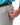 Close up on the Zippered pocket on the left leg of the Ace Pants on a model in front of a white background