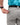 Close up on the Zippered pocket on the back left side of the Ace Pants on a model in front of a white background