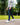 Model wearing the Ace Pants outside with greenery in the background