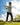 Model wearing the Stone Sunday Quarter Zip on the golf course with greenery and blue sky in the background