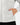 Close up on one of the front hand pockets on the Pheasants Forever Stride Jacket on a model in front of a light gray background.
