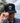 A male model wearing the Sunset Sauna Hat outside with greenery & blue sky in the background