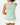 Back of the Real Dill Sleeveless Polo on a model in front of a light gray background.