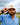 Conner wearing the Turn Hat on the golf course, with greenery and cloudy sky in the background.