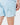 Close up on the Waggle W perferation on the Topographic Blue Momentum Shorts on a model in front of a light gray background.