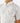 Close up on the left chest pocket on the Traveler Outpost Button-Down Shirt on a model in front of a light gray background.