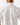 Close up on the back ventilation on the Traveler Outpost Button-Down Shirt on a model in front of a light gray background.