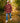 Model wearing the Twisted Tartan Flannel Overshirt outside walking down a wooded trail.