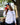 Female model wearing the Waggle Ice Fishing Tours Long Sleeve T-Shirt outside with buildings & greenery in the background