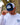 Model wearing the Waggle Ice Fishing Tours Trucker Hat outside doing a hat tilt with a tree and building in the background