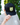 A male model wearing the Waggle Wildlife Trucker Hat outside with greenery in the background