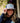 Model wearing the Wagglfest Trucker Hat outside with greenery and a building in the background