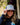 Model wearing the Wagglfest Trucker Hat outside with greenery and a building in the background