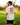 Model wearing the Waggleria Pizza T-Shirt outside with greenery in the background.