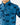 Close up on the left chest pocket on the Wake Life Outpost Button-Down Shirt on a model in front of a light gray background.