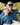 Father and son sitting on a golf cart smiling