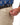 Close up on the Zippered pocket on the left leg of the Ace Pants on a model in front of a white background