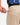 Close up on the Zippered pocket on the back left side of the Ace Pants on a model in front of a white background