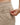 Close up on the Zippered pocket on the left leg of the Rhythm Pants on a model in front of a white background