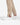 Close up on the ankle slit on the Rhythm Pants on a model in front of a white background