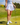 Model wearing the Flairway skort on the golf course with greenery in the background